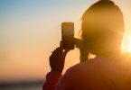 woman texting during sunset