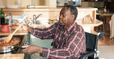 man in wheelchair cooking