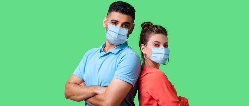 man and woman back to back with masks on for coronavirus protection