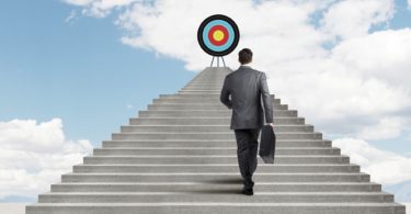 man walking up stairs to reach target