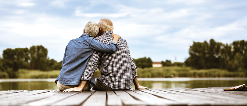 retired couple sitting on dock