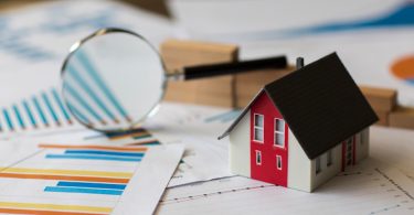 desk filled with real estate items