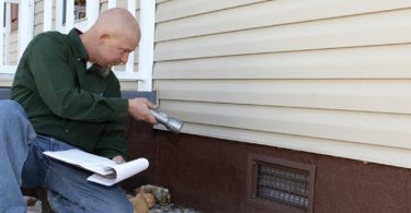 home inspector looking at house