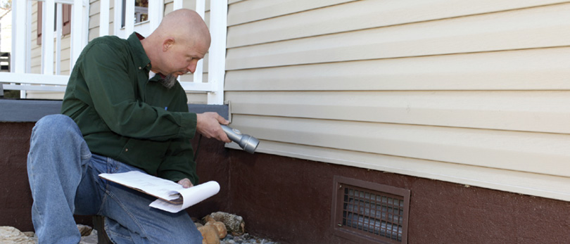 home inspector looking at house