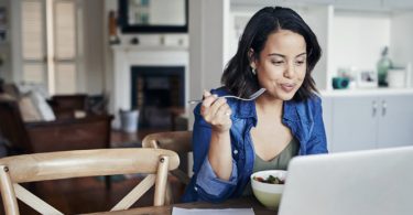 woman eating while working