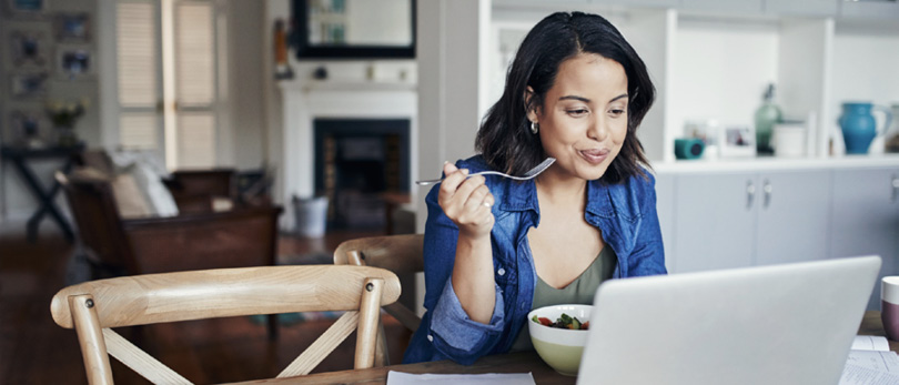 woman eating while working