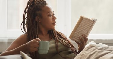 woman reading book with coffee