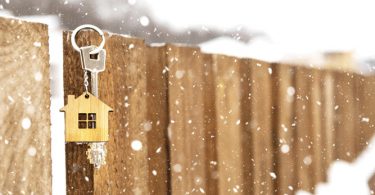 fence with birdhouse in winter