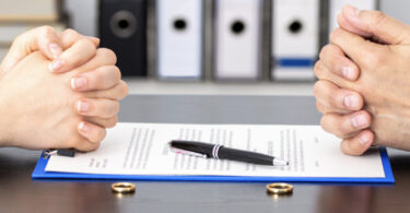 two people sitting at table with contract