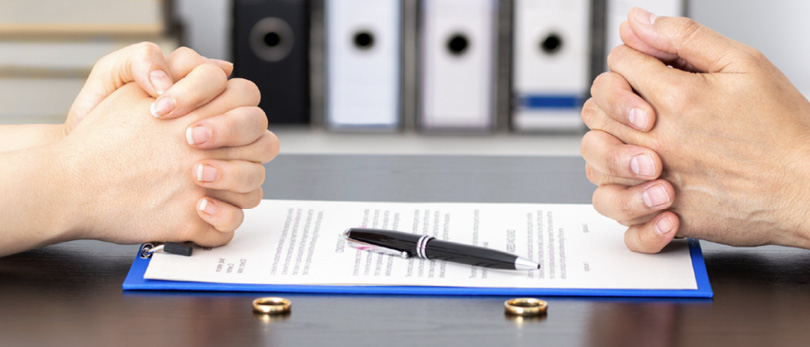 two people sitting at table with contract