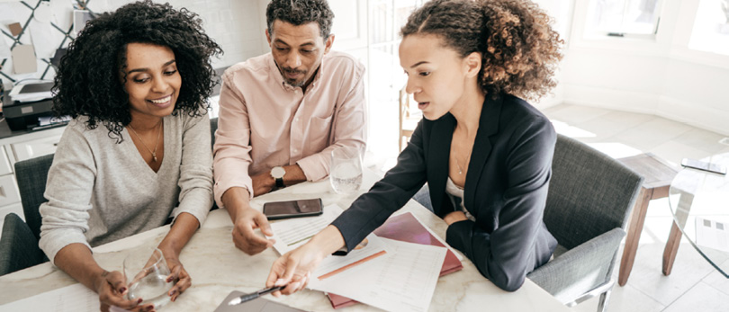 agent working on finances with clients