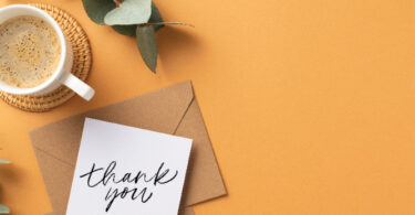 handwritten note on desk with coffee