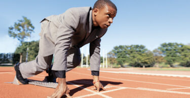 Man in suit ready to run race