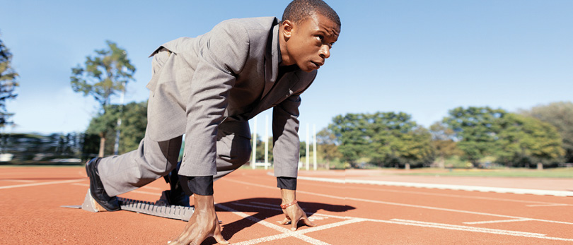 Man in suit ready to run race