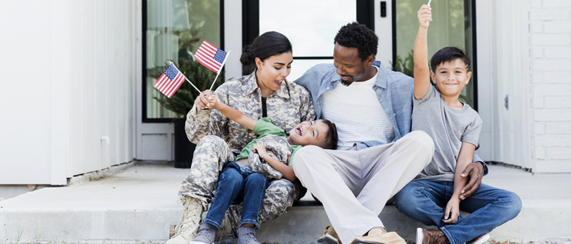 military family sitting on steps