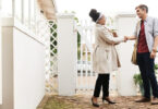 woman and man shaking hands at property