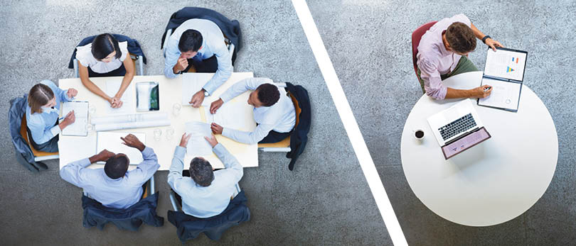 people sitting around a table vs. someone alone