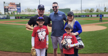 Eric Ravenscroft, CRS, with a family at a baseball game