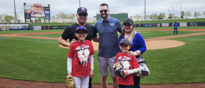 Eric Ravenscroft, CRS, with a family at a baseball game