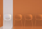 chairs with orange background with one highlighted white